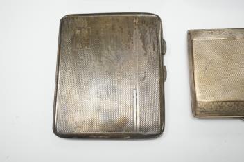 Three assorted silver cigarette cases including Art Deco, largest 10.1cm, a silver vesta case and a white metal cigarette case.